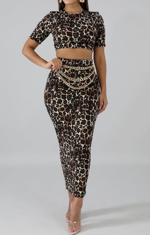 Featuring a body-hugging design with a round neckline, short sleeves, and matching midi skirt, leopard print 